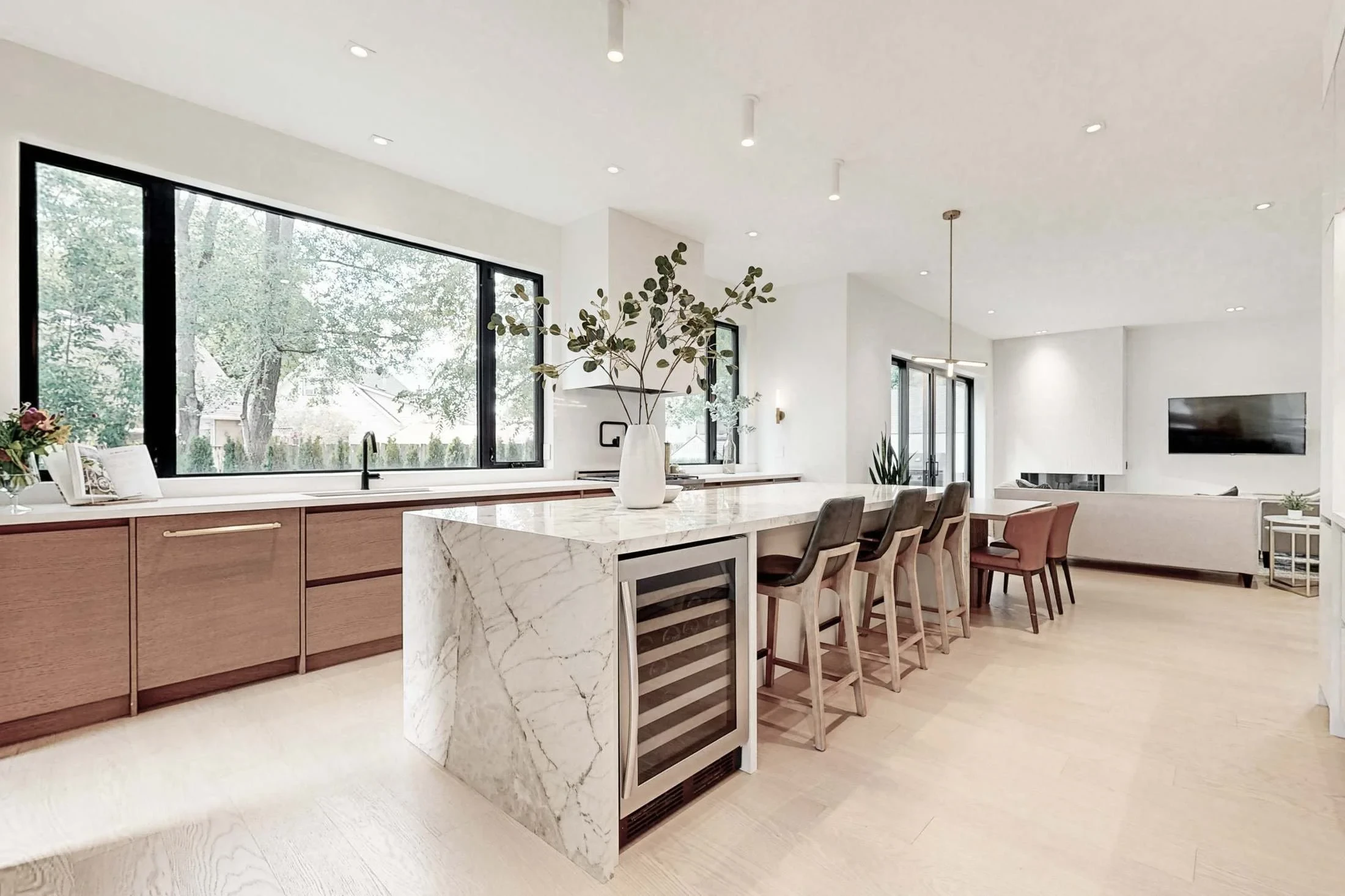 Secondary prep counter in matte white with a black faucet and bar sink looks toward a frosted glass door.